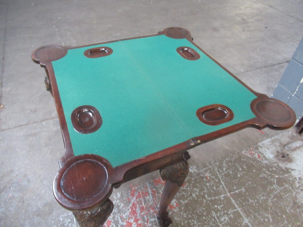 A Georgian mahogany fold-over card table featuring carved cabriole legs with acanthus knees and claw and ball feet. View X