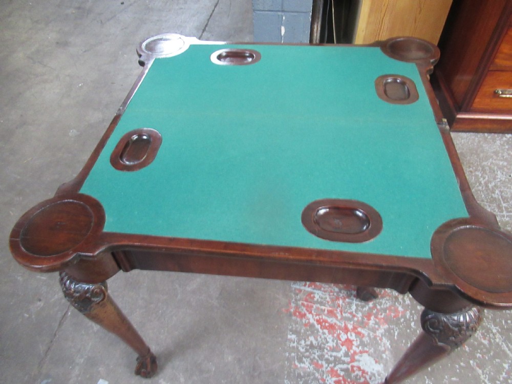 A Georgian mahogany fold-over card table featuring carved cabriole legs with acanthus knees and claw and ball feet. View XI