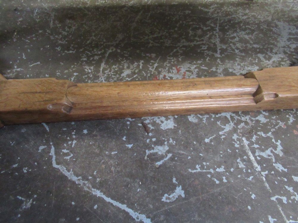 A rectangular light oak refectory dining table featuring carved aprons, spiral turned legs, and a low H-shaped stretcher base. View XII
