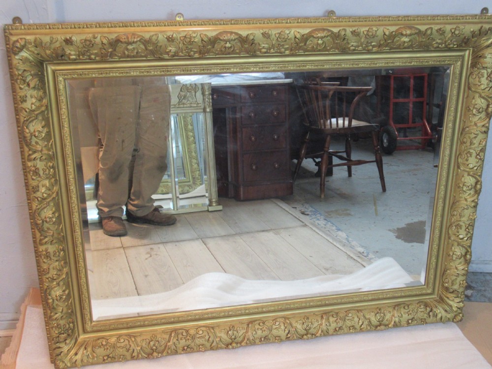 A large 1900s    deep gilt framed wall mirror 