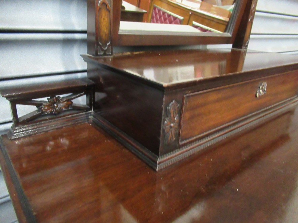 A dark mahogany Chippendale style dressing chest featuring four graduated drawers, brass handles, bracket feet, and a central arch-topped swing mirror. View XI