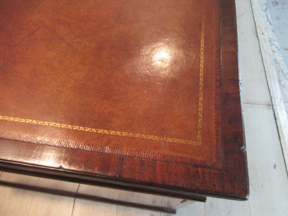A 19th-century mahogany kneehole desk featuring a leather inset writing surface, two frieze drawers with turned wooden knobs, and two side pedestal cupboards. View III