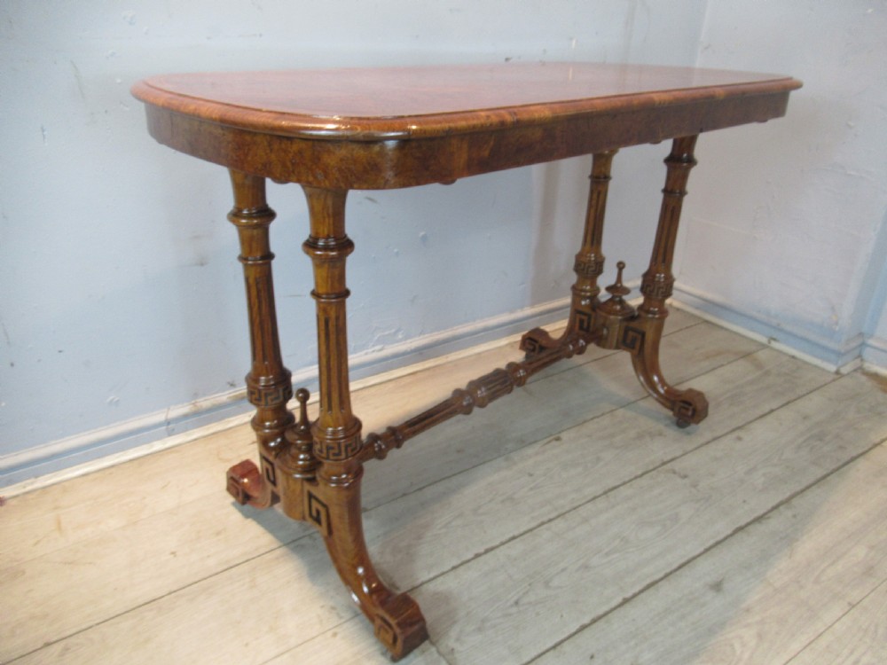 A Victorian burr oak side table featuring a polished rectangular top with rounded corners, supported by twin turned columns and a central finial stretcher.
