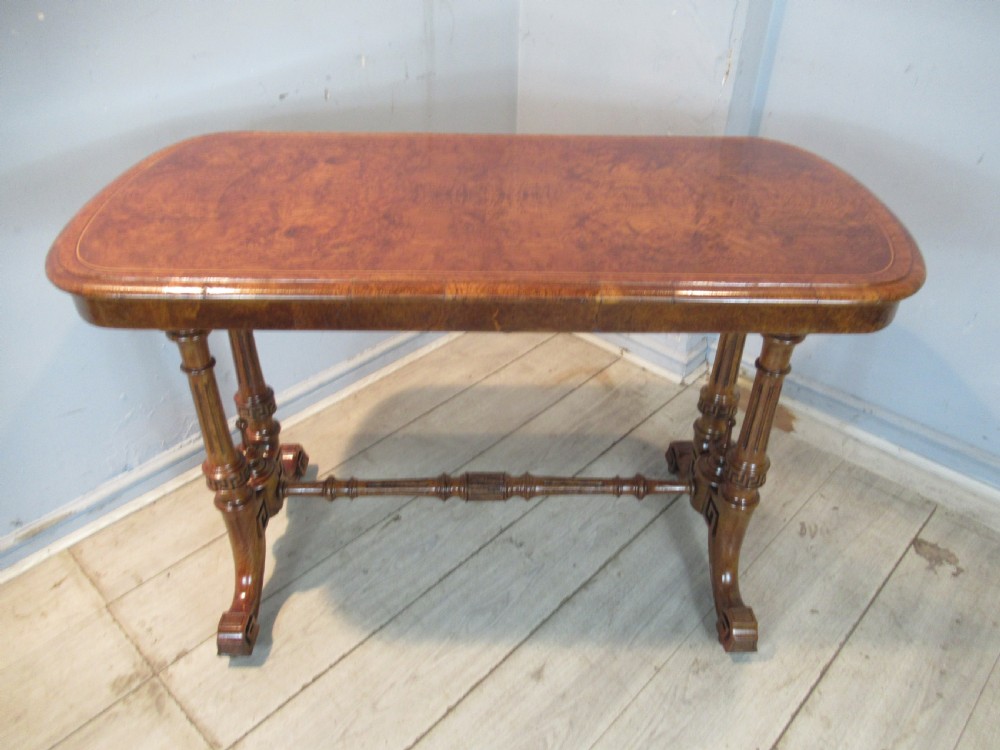 A Victorian burr oak side table featuring a polished rectangular top with rounded corners, supported by twin turned columns and a central finial stretcher. View II