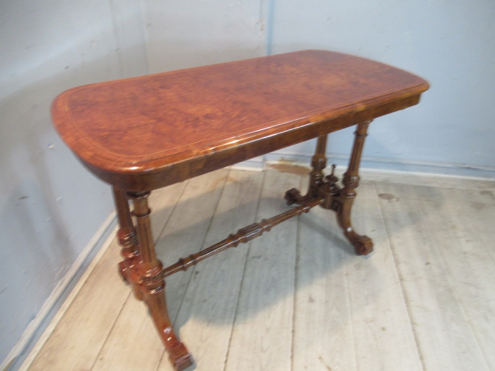A Victorian burr oak side table featuring a polished rectangular top with rounded corners, supported by twin turned columns and a central finial stretcher. View X