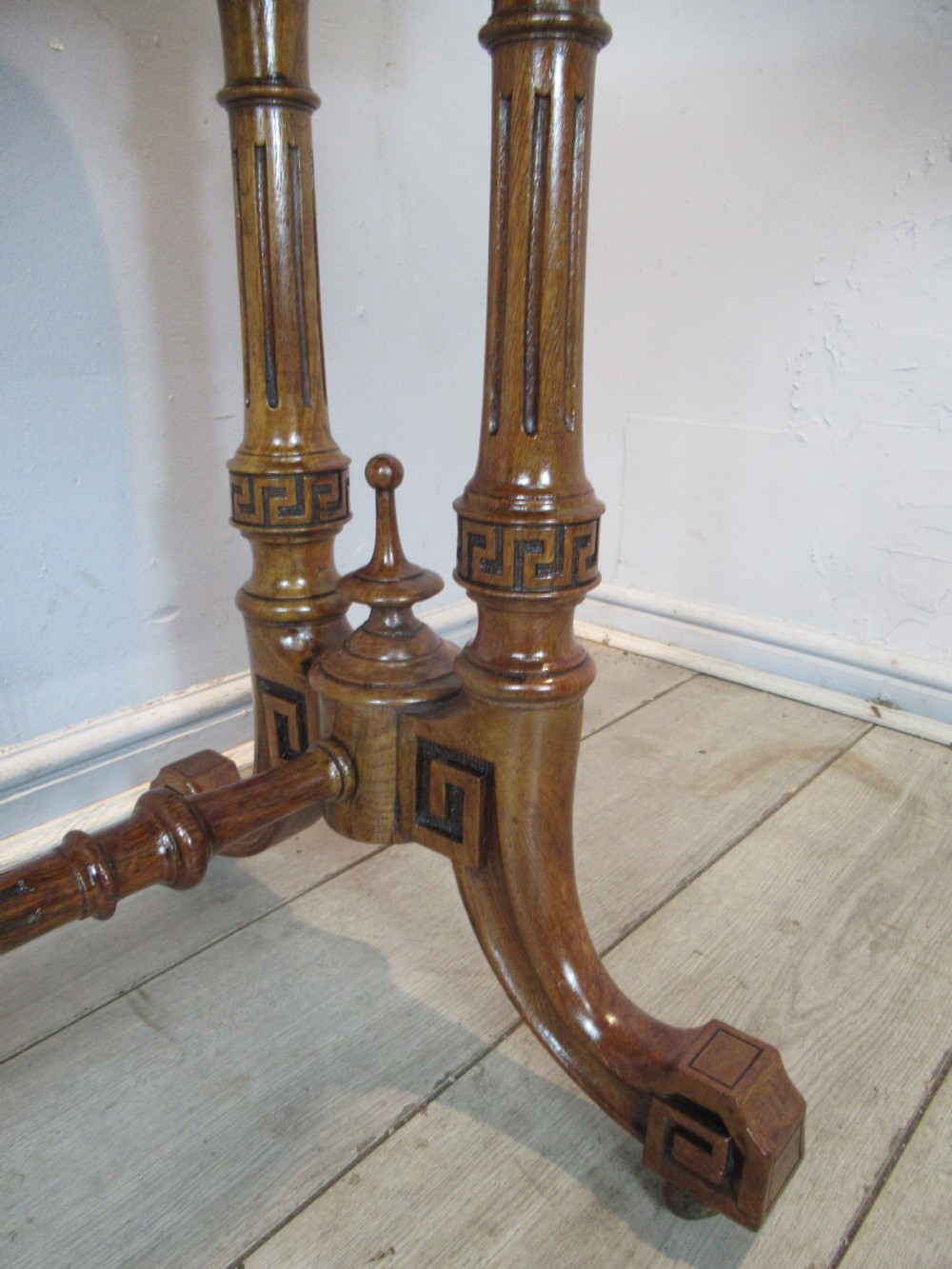 A Victorian burr oak side table featuring a polished rectangular top with rounded corners, supported by twin turned columns and a central finial stretcher. View XI