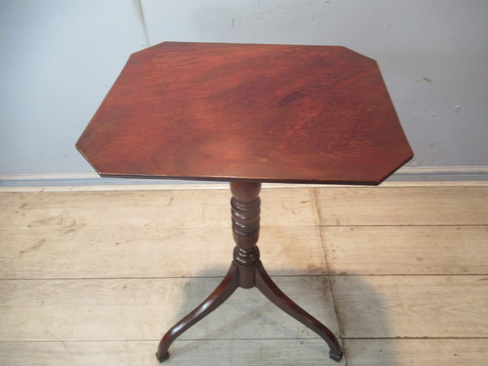 A 19th-century mahogany tripod side table featuring a clipped-corner top, turned central column, and three splayed legs. View IV