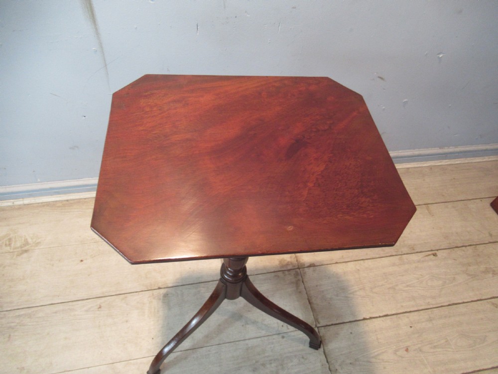 A 19th-century mahogany tripod side table featuring a clipped-corner top, turned central column, and three splayed legs. View V