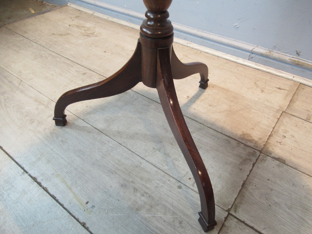A 19th-century mahogany tripod side table featuring a clipped-corner top, turned central column, and three splayed legs. View IX