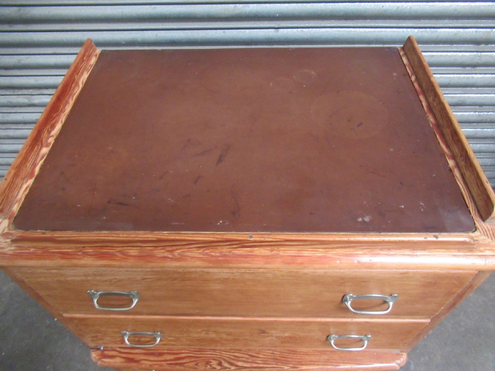 A pitch pine maritime chest of drawers featuring four drawers with flush metal handles and a raised gallery rim at the top. View IV