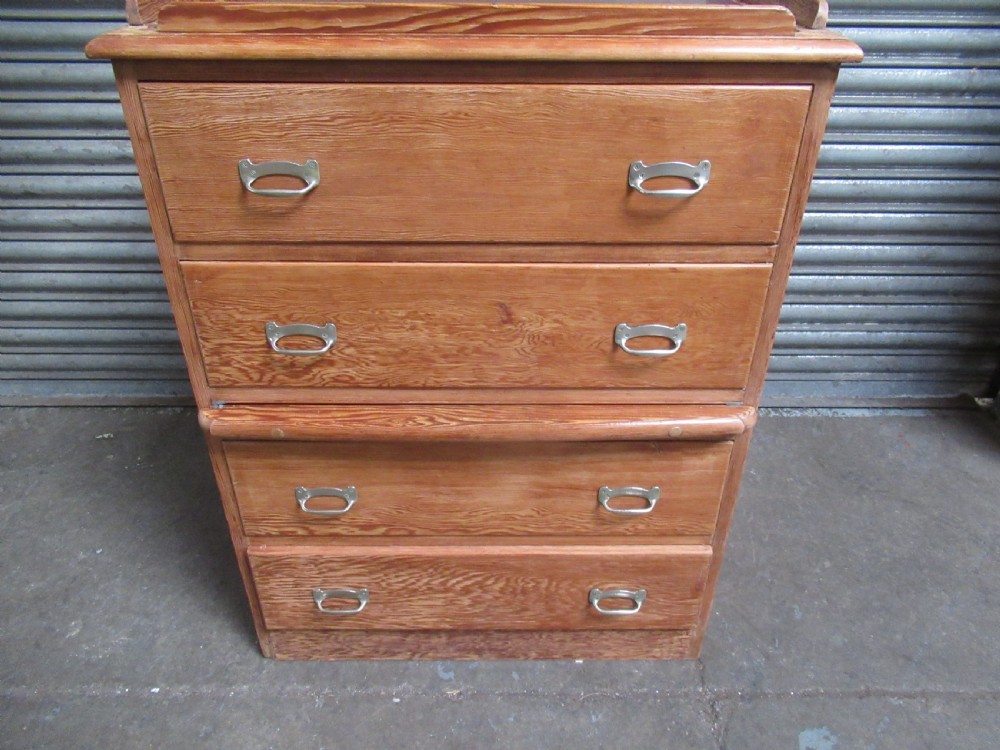 A pitch pine maritime chest of drawers featuring four drawers with flush metal handles and a raised gallery rim at the top. View XII