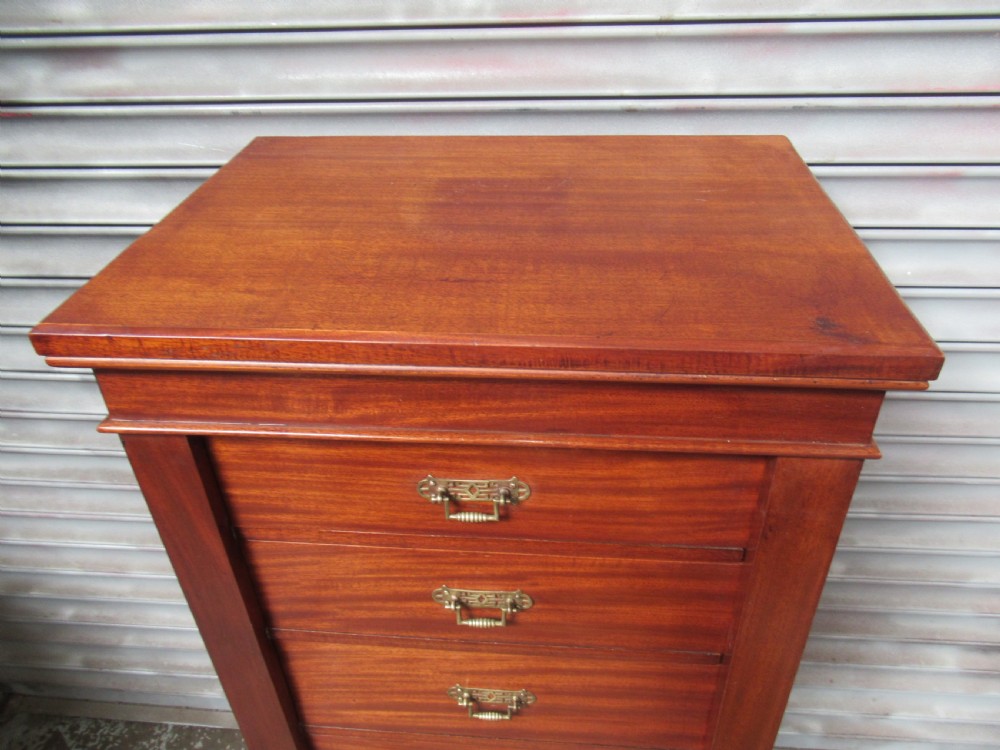 A tall, narrow Victorian mahogany Wellington chest with six drawers and brass bail handles. View IV