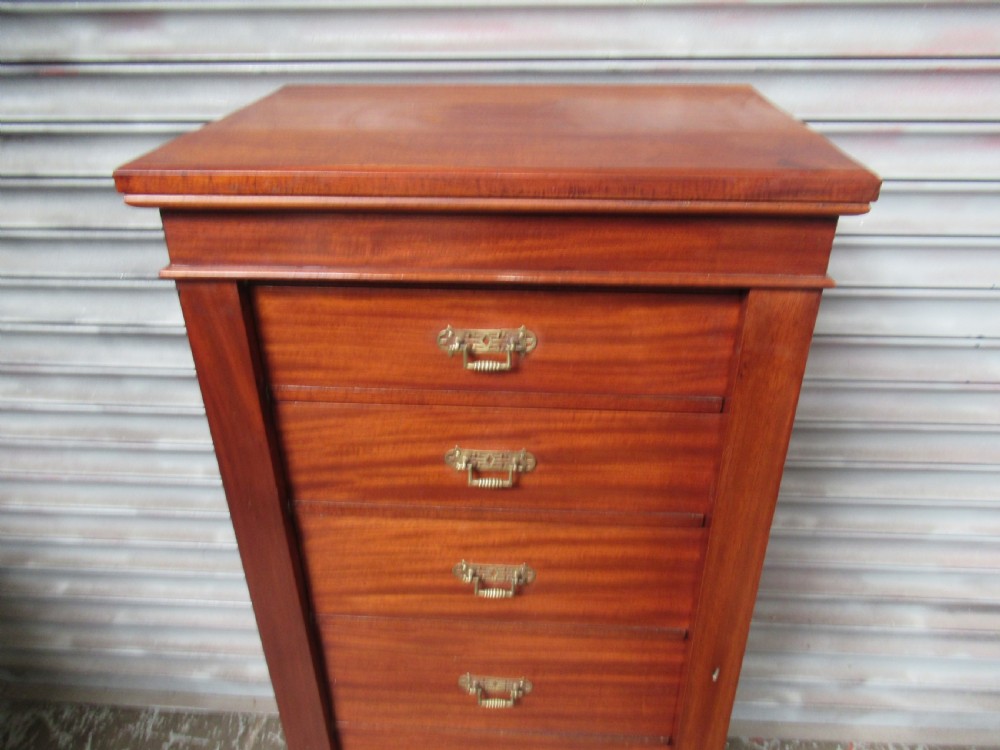 A tall, narrow Victorian mahogany Wellington chest with six drawers and brass bail handles. View IX