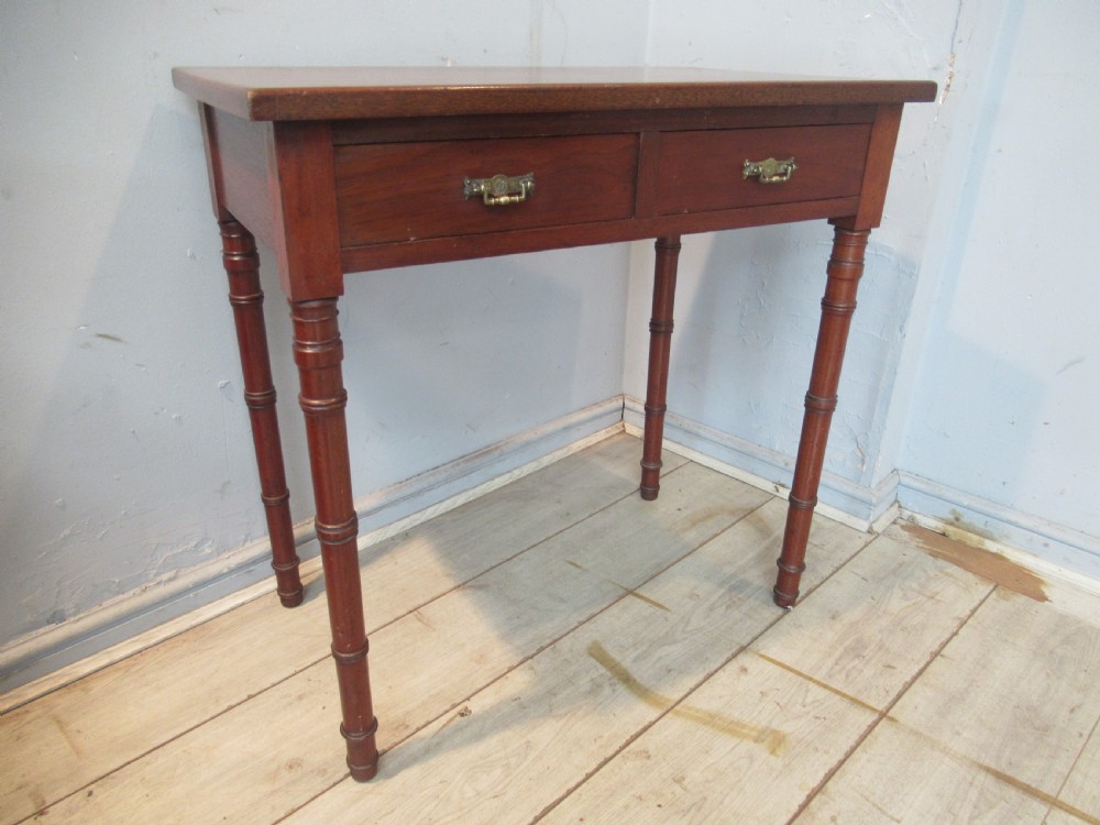 A late Victorian mahogany side table featuring two drawers with brass drop handles and four ring-turned bamboo-style legs. View III