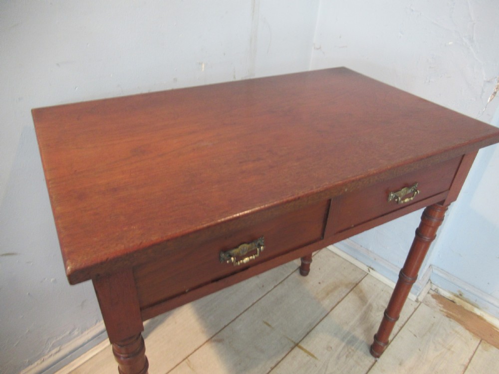 A late Victorian mahogany side table featuring two drawers with brass drop handles and four ring-turned bamboo-style legs. View VI
