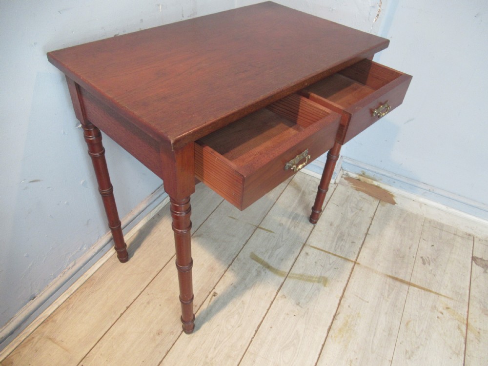 A late Victorian mahogany side table featuring two drawers with brass drop handles and four ring-turned bamboo-style legs. View XI