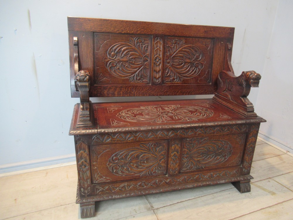 A carved oak monks bench seat   1920