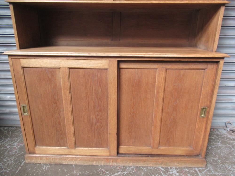 A light oak glazed dresser featuring leaded glass upper doors and a lower section with sliding panelled doors. View III