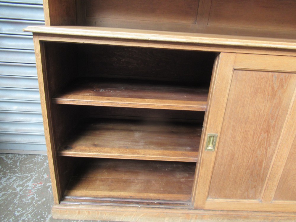A light oak glazed dresser featuring leaded glass upper doors and a lower section with sliding panelled doors. View IV