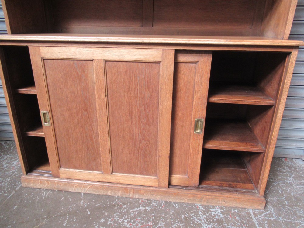 A light oak glazed dresser featuring leaded glass upper doors and a lower section with sliding panelled doors. View V