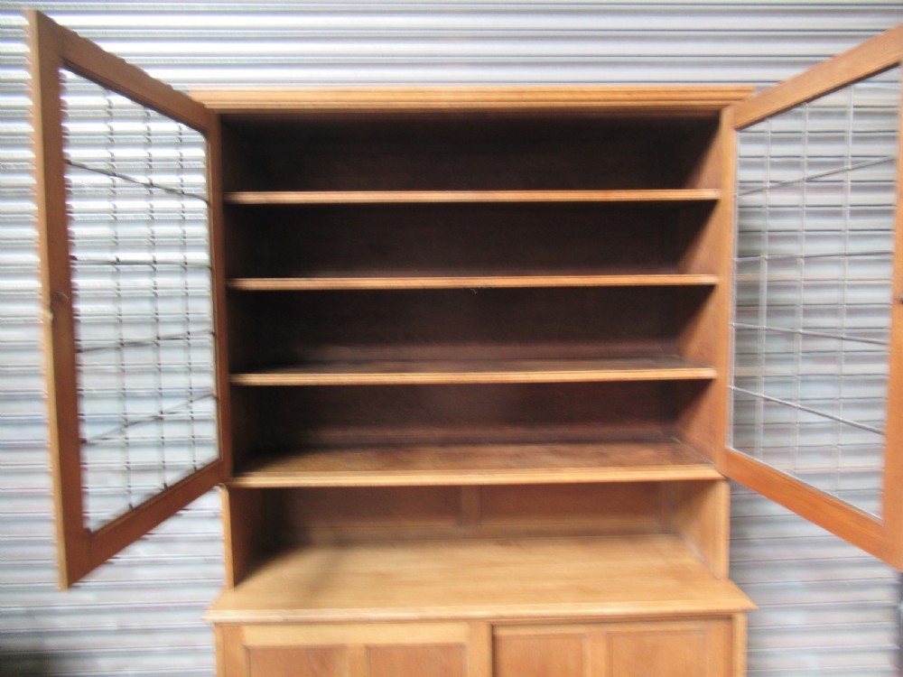 A light oak glazed dresser featuring leaded glass upper doors and a lower section with sliding panelled doors. View VIII