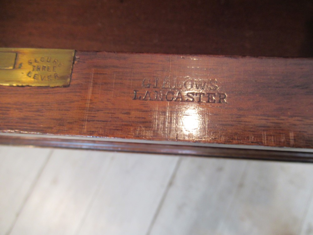 A late Victorian walnut pedestal desk featuring a dark leather writing inset, multiple burr walnut drawer fronts with brass knobs, and fluted column accents. View X