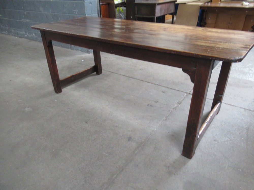 A 19th-century pine dining table with a wide plank top, straight legs, and side stretchers in a warm brown timber finish. View IX
