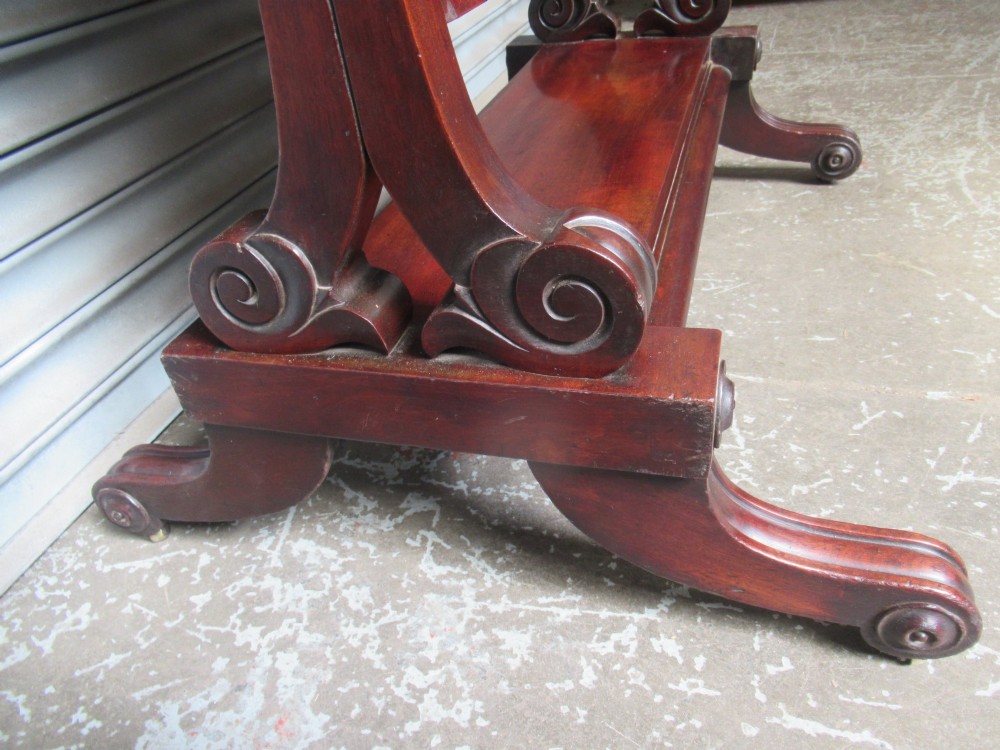 A 19th-century full-length mahogany cheval mirror featuring turned side adjustment handles, curved scroll legs, and a rectangular tilting glass frame. View VI