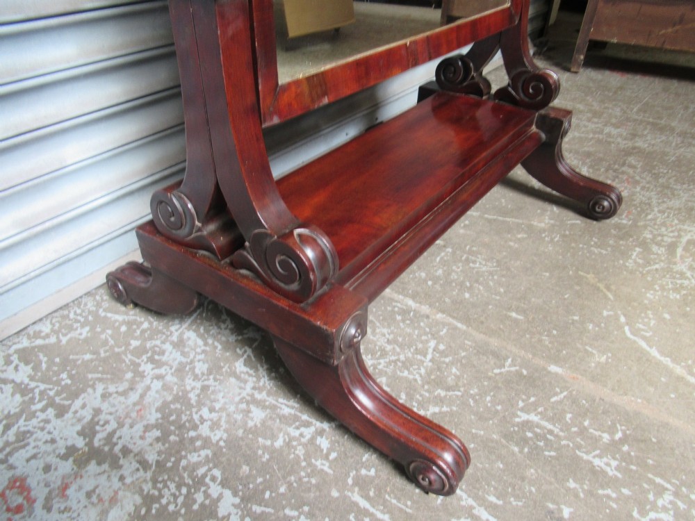 A 19th-century full-length mahogany cheval mirror featuring turned side adjustment handles, curved scroll legs, and a rectangular tilting glass frame. View VII