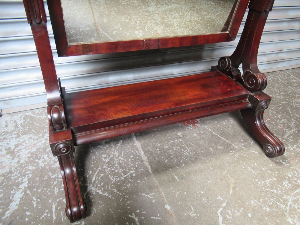 A 19th-century full-length mahogany cheval mirror featuring turned side adjustment handles, curved scroll legs, and a rectangular tilting glass frame. View VIII