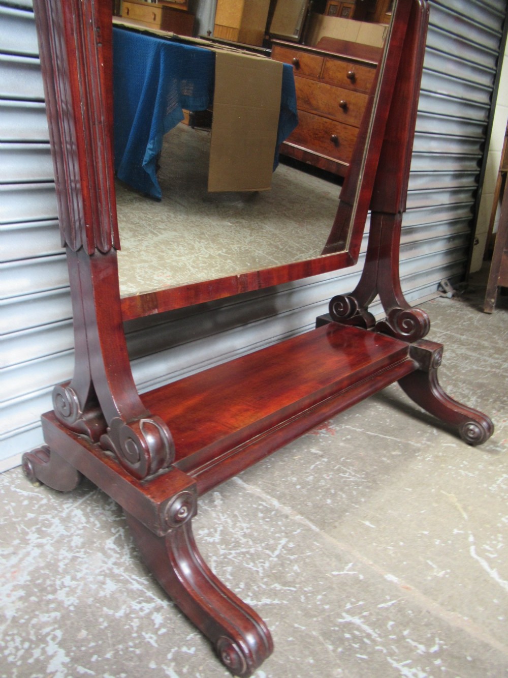 A 19th-century full-length mahogany cheval mirror featuring turned side adjustment handles, curved scroll legs, and a rectangular tilting glass frame. View IX