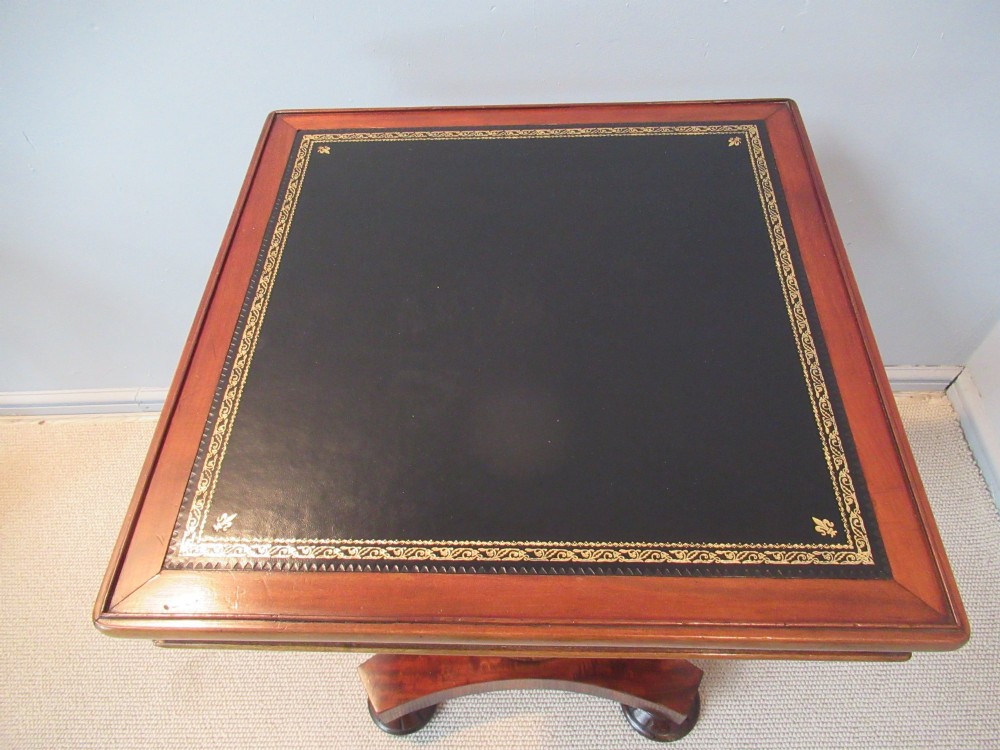 A 19th-century square mahogany side table featuring a dark leather top with gilt tooling, supported by a central turned pedestal and a quadform base. View III