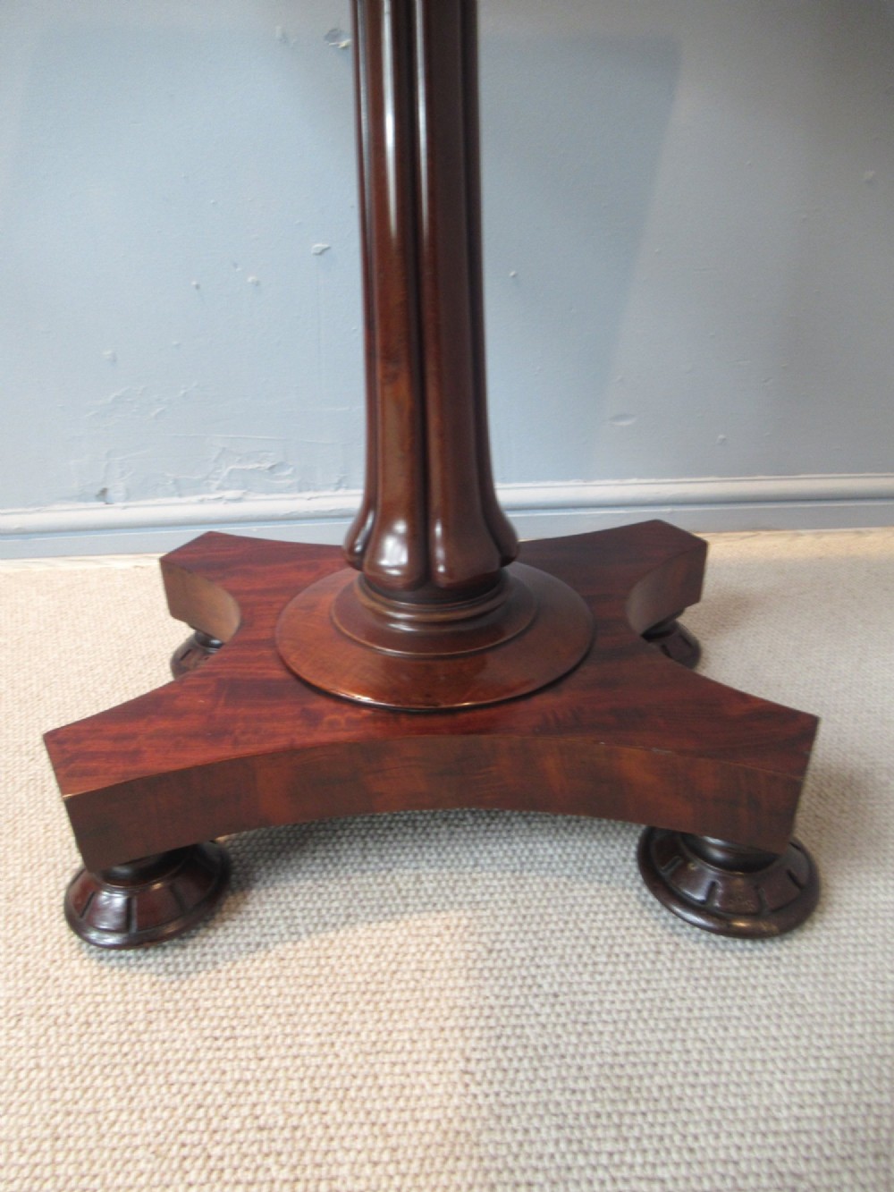 A 19th-century square mahogany side table featuring a dark leather top with gilt tooling, supported by a central turned pedestal and a quadform base. View VII