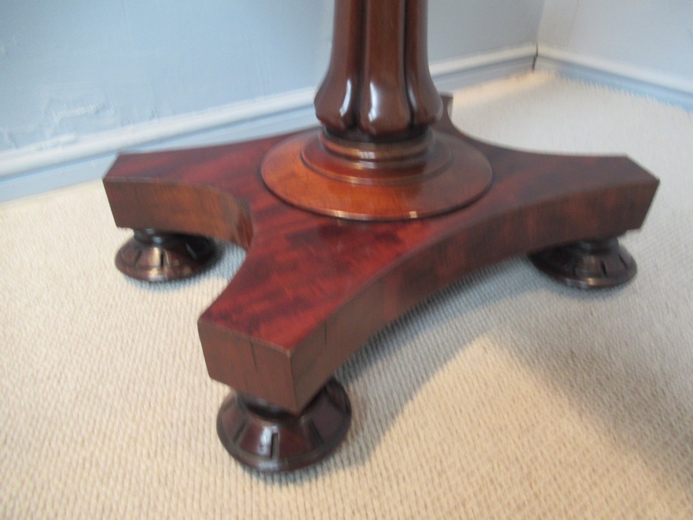 A 19th-century square mahogany side table featuring a dark leather top with gilt tooling, supported by a central turned pedestal and a quadform base. View VIII
