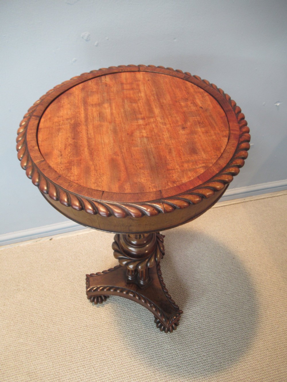 A 19th-century mahogany circular plant stand featuring a carved rope-twist rim, turned central column, and tripod base. View II
