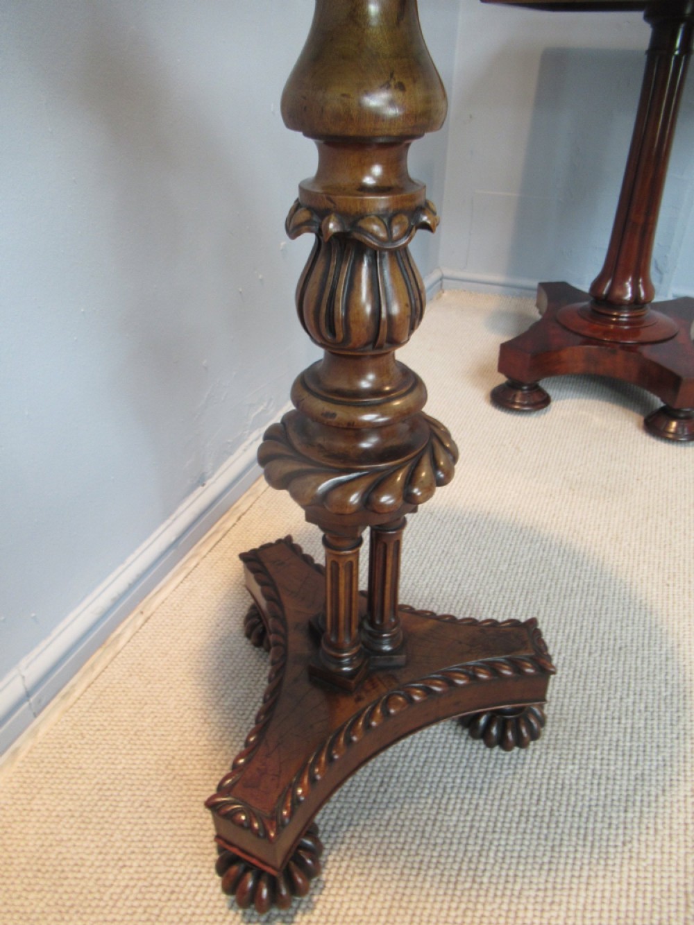 A 19th-century mahogany circular plant stand featuring a carved rope-twist rim, turned central column, and tripod base. View V