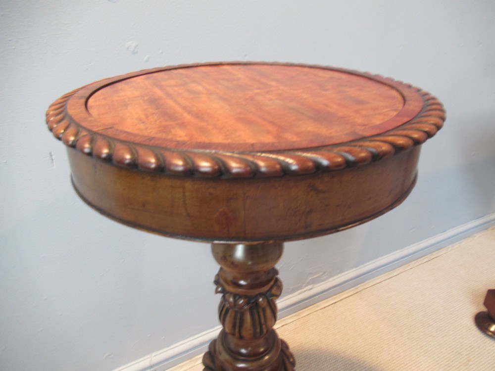 A 19th-century mahogany circular plant stand featuring a carved rope-twist rim, turned central column, and tripod base. View VI