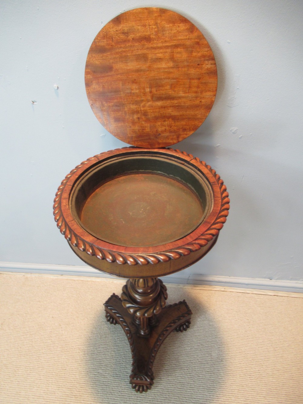 A 19th-century mahogany circular plant stand featuring a carved rope-twist rim, turned central column, and tripod base. View VII