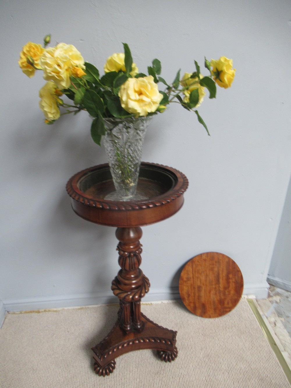A 19th-century mahogany circular plant stand featuring a carved rope-twist rim, turned central column, and tripod base. View XI