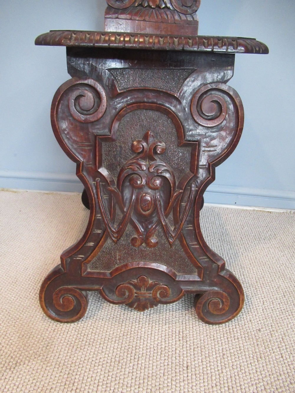 A Victorian carved mahogany hall chair featuring a detailed lion head mask sculpted into the backrest and a solid timber seat. View III