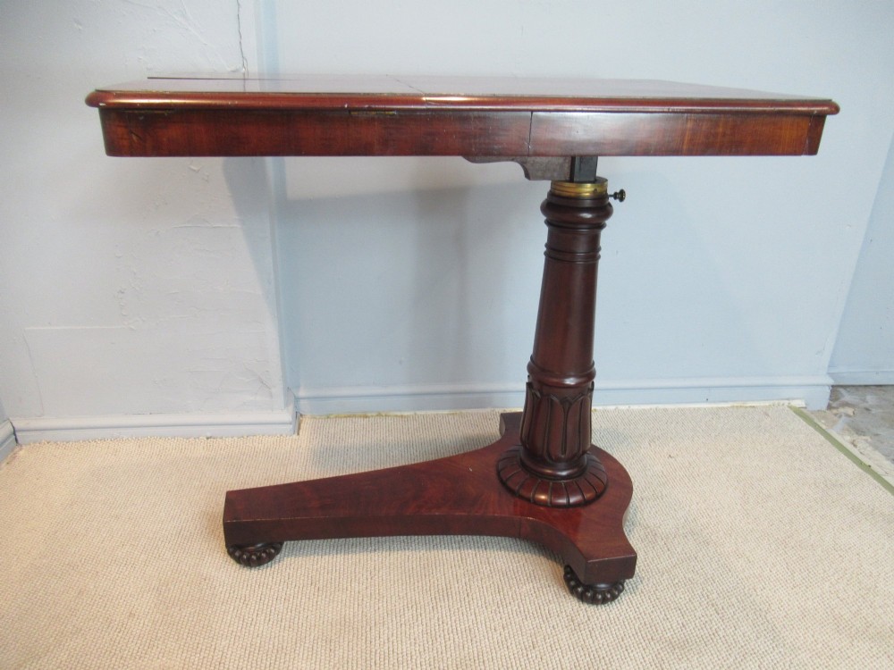 A 19th-century mahogany adjustable reading table featuring dual hinged ratcheted slopes on a turned pedestal base with an open side drawer. View VI