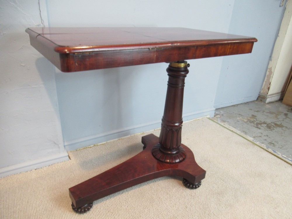 A 19th-century mahogany adjustable reading table featuring dual hinged ratcheted slopes on a turned pedestal base with an open side drawer. View VII