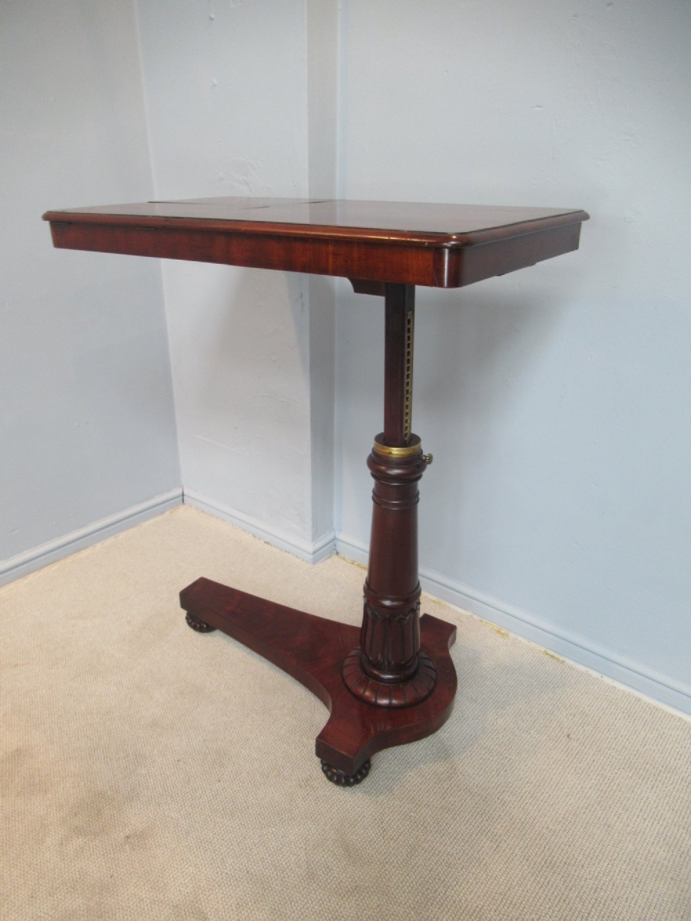 A 19th-century mahogany adjustable reading table featuring dual hinged ratcheted slopes on a turned pedestal base with an open side drawer. View IX