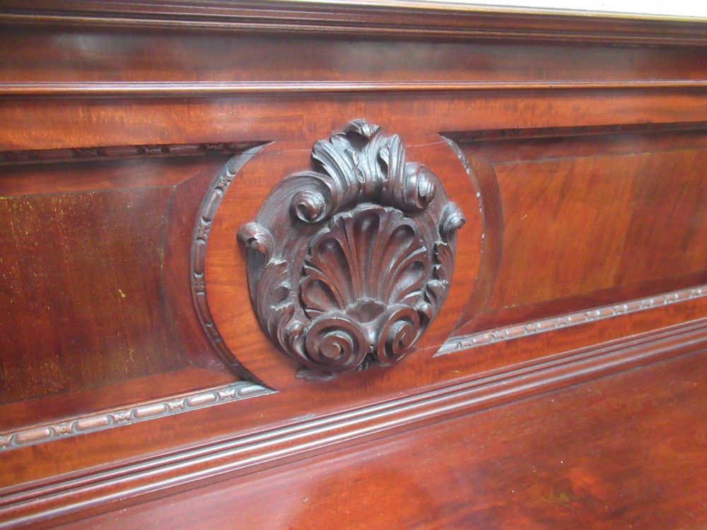 An Edwardian carved mahogany sideboard featuring a raised backboard with a carved shell motif, central bow-front drawers, side cupboard doors, and cabriole legs with ball and claw feet. View XII