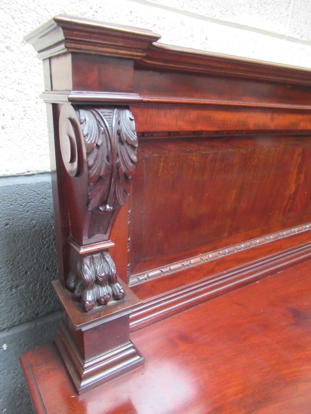 An Edwardian carved mahogany sideboard featuring a raised backboard with a carved shell motif, central bow-front drawers, side cupboard doors, and cabriole legs with ball and claw feet. View XIII