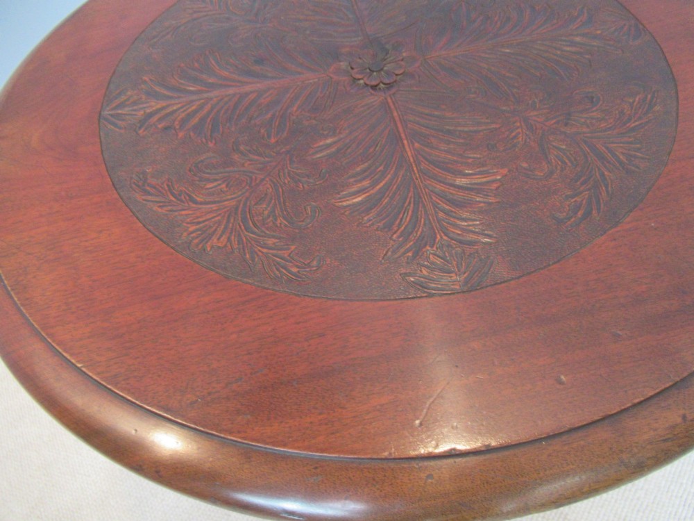 A round Victorian mahogany side table featuring a carved top, turned spindle legs, and a lower carved shelf. View III