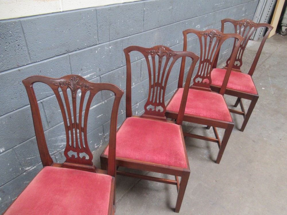 A set of four Edwardian mahogany dining chairs with carved pierced back splats and red velvet upholstered seats. View II