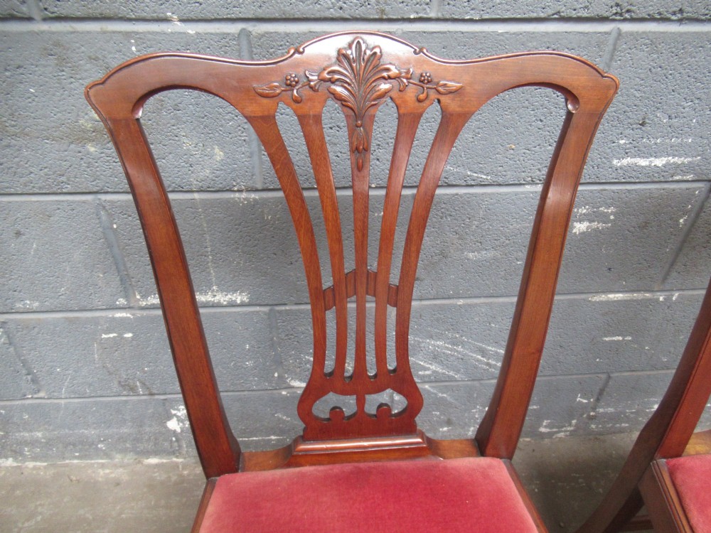 A set of four Edwardian mahogany dining chairs with carved pierced back splats and red velvet upholstered seats. View III