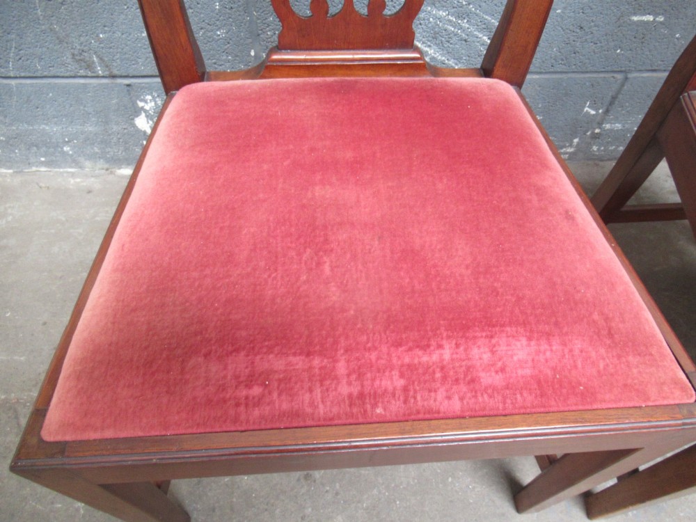 A set of four Edwardian mahogany dining chairs with carved pierced back splats and red velvet upholstered seats. View IV