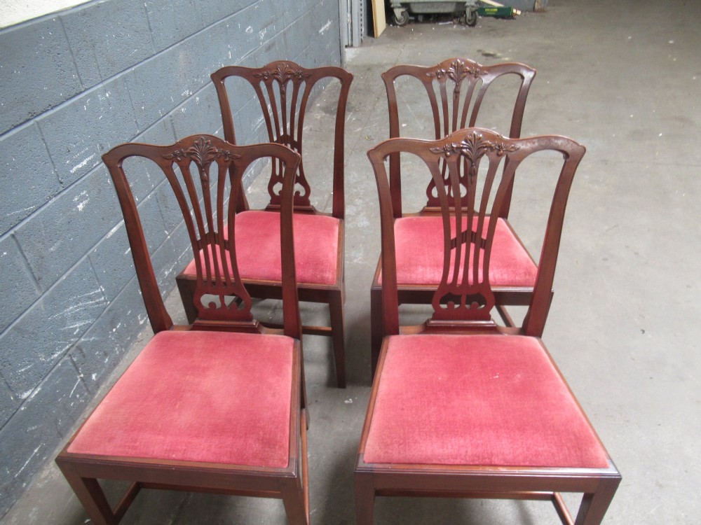 A set of four Edwardian mahogany dining chairs with carved pierced back splats and red velvet upholstered seats. View VI